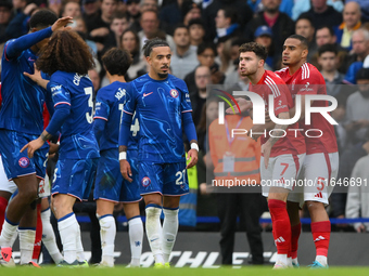 Neco Williams of Nottingham Forest is furious with Marc Cucurella of Chelsea during the Premier League match between Chelsea and Nottingham...