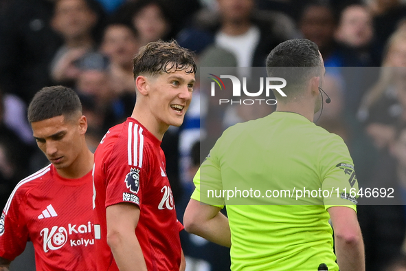 Ryan Yates of Nottingham Forest talks with referee Chris Kavanagh during the Premier League match between Chelsea and Nottingham Forest at S...