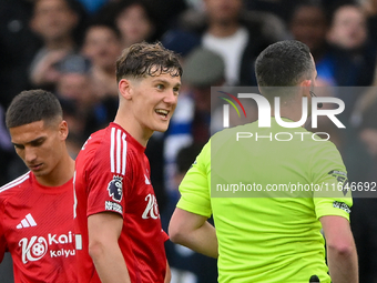 Ryan Yates of Nottingham Forest talks with referee Chris Kavanagh during the Premier League match between Chelsea and Nottingham Forest at S...