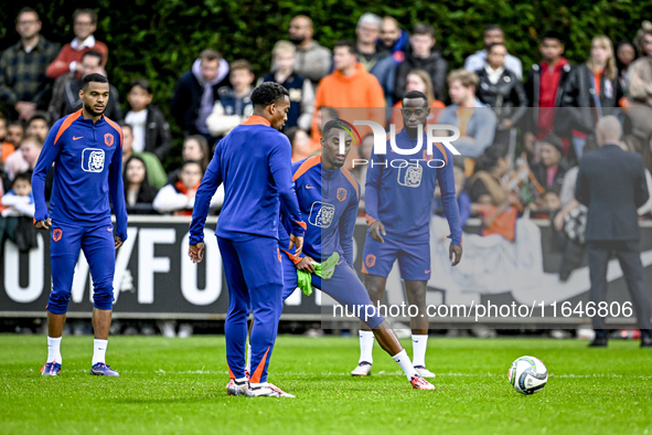 Netherlands players Cody Gakpo, Ryan Gravenberch, and Lutsharel Geertruida participate in the training and press conference for the Netherla...