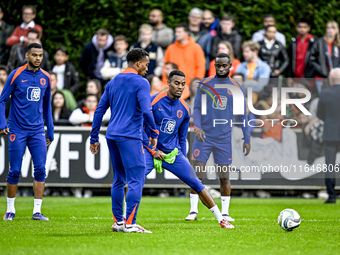 Netherlands players Cody Gakpo, Ryan Gravenberch, and Lutsharel Geertruida participate in the training and press conference for the Netherla...