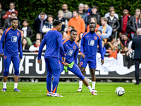 Netherlands players Cody Gakpo, Ryan Gravenberch, and Lutsharel Geertruida participate in the training and press conference for the Netherla...