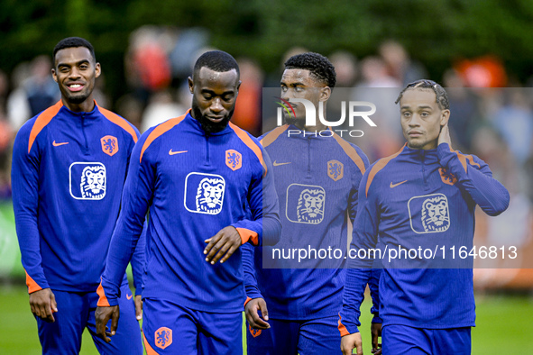 Netherlands players Lutsharel Geertruida, Xavi Simons, and Jorrel Hato participate in the training and press conference for the Netherlands...