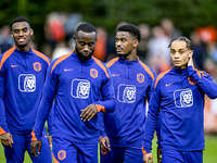 Netherlands players Lutsharel Geertruida, Xavi Simons, and Jorrel Hato participate in the training and press conference for the Netherlands...