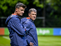 Netherlands assistant trainer Wim Jonk and Netherlands assistant trainer Erwin Koeman participate in the training and press conference for t...