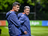 Netherlands assistant trainer Wim Jonk and Netherlands assistant trainer Erwin Koeman participate in the training and press conference for t...