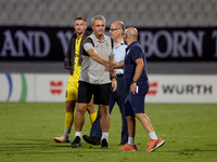 In Ta' Qali, Malta, on October 2, 2024, Branko Nisevic, head coach of Hibernians, shakes hands with Hamrun Spartans assistant coach Alessand...