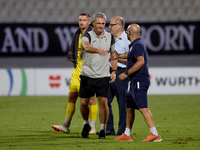 In Ta' Qali, Malta, on October 2, 2024, Branko Nisevic, head coach of Hibernians, shakes hands with Hamrun Spartans assistant coach Alessand...