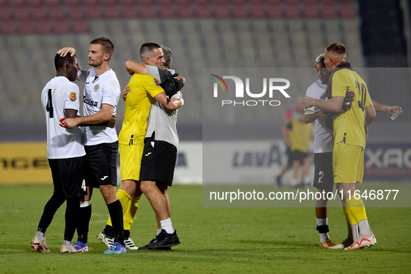 In Ta' Qali, Malta, on October 2, 2024, Branko Nisevic, head coach of Hibernians, celebrates with goalkeeper Hugo Sacco after the Malta 360...