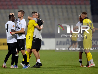 In Ta' Qali, Malta, on October 2, 2024, Branko Nisevic, head coach of Hibernians, celebrates with goalkeeper Hugo Sacco after the Malta 360...