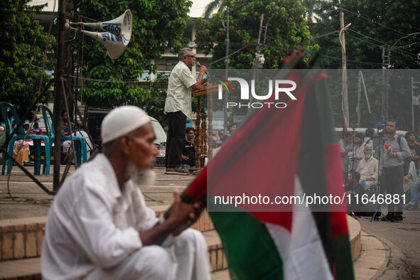 Anu Muhammad, a Bangladeshi economist, public intellectual, writer, editor, and political activist, speaks at a rally in front of Raju Memor...