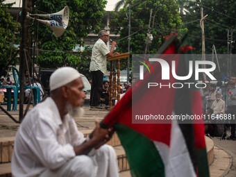 Anu Muhammad, a Bangladeshi economist, public intellectual, writer, editor, and political activist, speaks at a rally in front of Raju Memor...