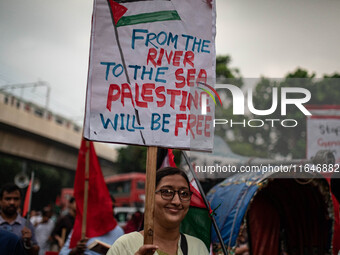 The Palestine Solidarity Committee, Bangladesh holds a rally and mass procession in front of the Raju Memorial Sculpture at TSC of Dhaka Uni...