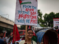 The Palestine Solidarity Committee, Bangladesh holds a rally and mass procession in front of the Raju Memorial Sculpture at TSC of Dhaka Uni...