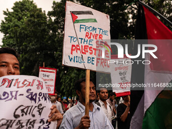 The Palestine Solidarity Committee, Bangladesh holds a rally and mass procession in front of the Raju Memorial Sculpture at TSC of Dhaka Uni...