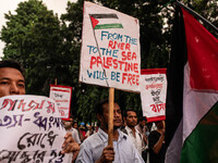 The Palestine Solidarity Committee, Bangladesh holds a rally and mass procession in front of the Raju Memorial Sculpture at TSC of Dhaka Uni...