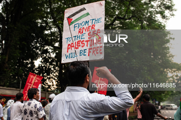 The Palestine Solidarity Committee, Bangladesh holds a rally and mass procession in front of the Raju Memorial Sculpture at TSC of Dhaka Uni...