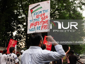 The Palestine Solidarity Committee, Bangladesh holds a rally and mass procession in front of the Raju Memorial Sculpture at TSC of Dhaka Uni...