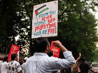 The Palestine Solidarity Committee, Bangladesh holds a rally and mass procession in front of the Raju Memorial Sculpture at TSC of Dhaka Uni...