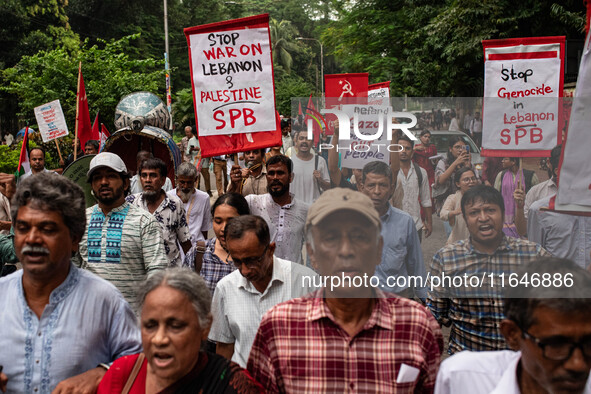 The Palestine Solidarity Committee, Bangladesh holds a rally and mass procession in front of the Raju Memorial Sculpture at TSC of Dhaka Uni...