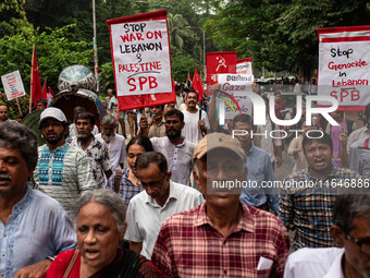 The Palestine Solidarity Committee, Bangladesh holds a rally and mass procession in front of the Raju Memorial Sculpture at TSC of Dhaka Uni...