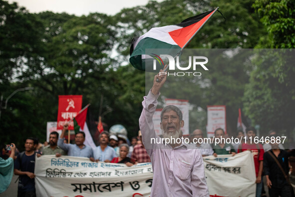 The Palestine Solidarity Committee, Bangladesh holds a rally and mass procession in front of the Raju Memorial Sculpture at TSC of Dhaka Uni...