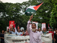 The Palestine Solidarity Committee, Bangladesh holds a rally and mass procession in front of the Raju Memorial Sculpture at TSC of Dhaka Uni...