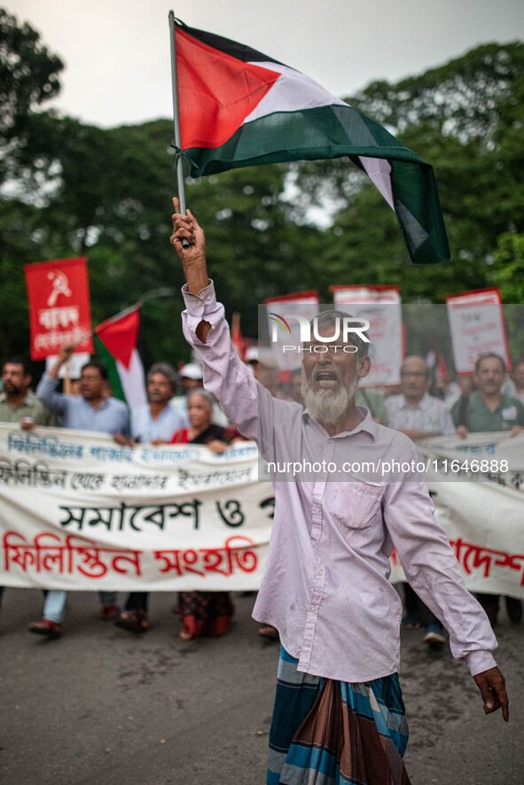 The Palestine Solidarity Committee, Bangladesh holds a rally and mass procession in front of the Raju Memorial Sculpture at TSC of Dhaka Uni...