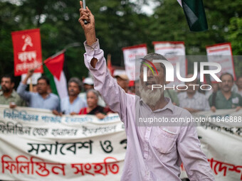 The Palestine Solidarity Committee, Bangladesh holds a rally and mass procession in front of the Raju Memorial Sculpture at TSC of Dhaka Uni...