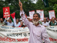 The Palestine Solidarity Committee, Bangladesh holds a rally and mass procession in front of the Raju Memorial Sculpture at TSC of Dhaka Uni...