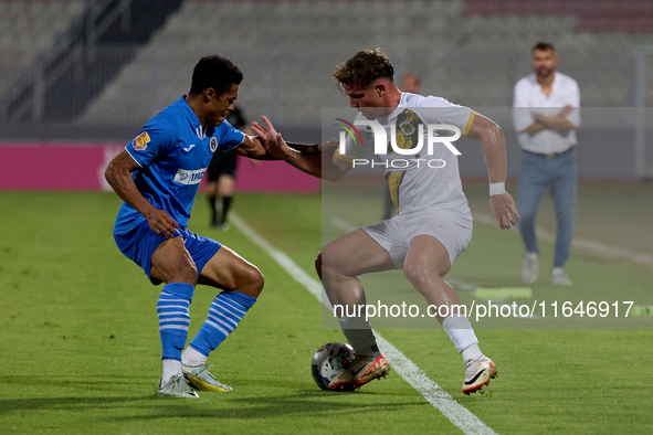 In Ta' Qali, Malta, on October 2, 2024, Enmy Manuel Pena Beltre of Marsaxlokk competes for the ball with Sean Gatt of Zabbar St. Patrick dur...