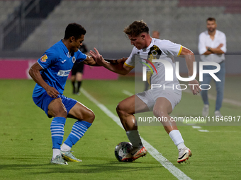 In Ta' Qali, Malta, on October 2, 2024, Enmy Manuel Pena Beltre of Marsaxlokk competes for the ball with Sean Gatt of Zabbar St. Patrick dur...