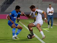 In Ta' Qali, Malta, on October 2, 2024, Enmy Manuel Pena Beltre of Marsaxlokk competes for the ball with Sean Gatt of Zabbar St. Patrick dur...