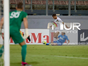 In Ta' Qali, Malta, on October 2, 2024, Diogo Joao Regala De Figueiredo Tavares (back) is challenged by Yuri De Jesus Messias (front) of Mar...