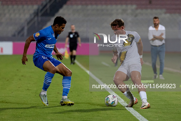 In Ta' Qali, Malta, on October 2, 2024, Enmy Manuel Pena Beltre of Marsaxlokk competes for the ball with Sean Gatt of Zabbar St. Patrick dur...