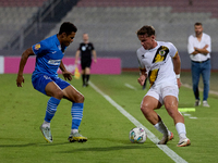 In Ta' Qali, Malta, on October 2, 2024, Enmy Manuel Pena Beltre of Marsaxlokk competes for the ball with Sean Gatt of Zabbar St. Patrick dur...