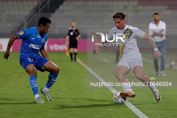 In Ta' Qali, Malta, on October 2, 2024, Enmy Manuel Pena Beltre of Marsaxlokk competes for the ball with Sean Gatt of Zabbar St. Patrick dur...