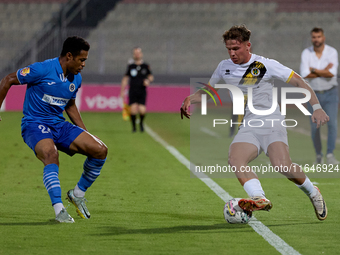 In Ta' Qali, Malta, on October 2, 2024, Enmy Manuel Pena Beltre of Marsaxlokk competes for the ball with Sean Gatt of Zabbar St. Patrick dur...