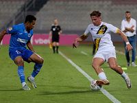 In Ta' Qali, Malta, on October 2, 2024, Enmy Manuel Pena Beltre of Marsaxlokk competes for the ball with Sean Gatt of Zabbar St. Patrick dur...