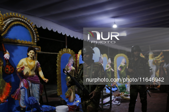 A member of the Bangladesh Army patrols at a temple ahead of the Durga Puja festival, the largest festival of the Hindu community, in Dhaka,...