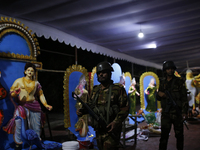 A member of the Bangladesh Army patrols at a temple ahead of the Durga Puja festival, the largest festival of the Hindu community, in Dhaka,...