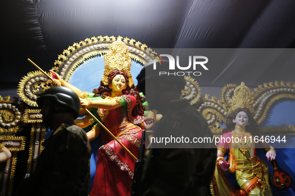 A member of the Bangladesh Army patrols at a temple ahead of the Durga Puja festival, the largest festival of the Hindu community, in Dhaka,...