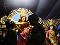 A member of the Bangladesh Army patrols at a temple ahead of the Durga Puja festival, the largest festival of the Hindu community, in Dhaka,...