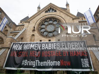 The large banner of ''bringthemhomenow'' hangs on the Roonstrasse Synagogue in Cologne, Germany, on October 7, 2024. (