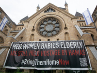 The large banner of ''bringthemhomenow'' hangs on the Roonstrasse Synagogue in Cologne, Germany, on October 7, 2024. (