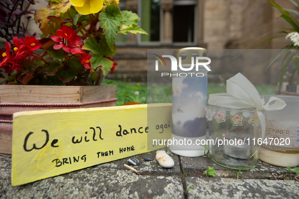 The candlelight and flowers are seen in front of the Roonstrasse Synagogue in Cologne, Germany, on October 7, 2024. 