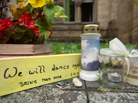 The candlelight and flowers are seen in front of the Roonstrasse Synagogue in Cologne, Germany, on October 7, 2024. (