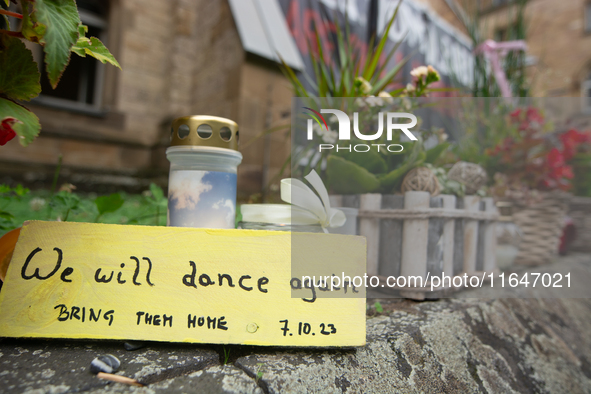 The candlelight and flowers are seen in front of the Roonstrasse Synagogue in Cologne, Germany, on October 7, 2024. 