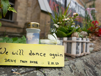 The candlelight and flowers are seen in front of the Roonstrasse Synagogue in Cologne, Germany, on October 7, 2024. (