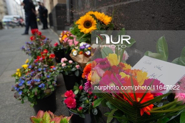 The candlelight and flowers are seen in front of the Roonstrasse Synagogue in Cologne, Germany, on October 7, 2024. 